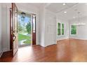 Grand entryway featuring hardwood floors, elegant lighting, and view to landscaped front yard through the open door at 2697 N Thompson Ne Rd, Atlanta, GA 30319