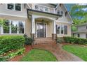 Inviting front porch and beautiful landscaping featuring stone pathway leading up to the front door with brick entryway at 2697 N Thompson Ne Rd, Atlanta, GA 30319