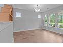 Bright living room with hardwood floors and large windows at 4830 Briscoe Dr, Cumming, GA 30028