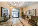 Elegant building lobby featuring tiled floors, seating, and a modern chandelier at 230 E Ponce De Leon Ave # 324, Decatur, GA 30030