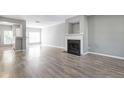 Open-concept living room with fireplace and modern wood flooring at 2566 Walden Lake Dr, Decatur, GA 30035