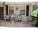 Inviting front porch featuring comfortable seating, neutral rug, and a welcoming 'hello' sign at 3227 Due West Rd, Dallas, GA 30157