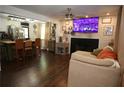 Inviting living room featuring a fireplace, mounted tv, and open access to the kitchen at 3227 Due West Rd, Dallas, GA 30157