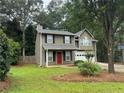 Attractive two-story house with black shutters, green lawn, and an attached two-car garage at 525 Cherokee Overlook Ct, Canton, GA 30115