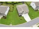 Aerial view of home on spacious lot with large, green lawn, two-car garage, and fenced backyard at 6825 Rambling Vale, Cumming, GA 30028
