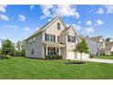 Well-maintained two-story home with lush green lawn, two-car garage, and attractive landscaping at 6825 Rambling Vale, Cumming, GA 30028