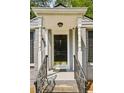 Welcoming front door framed by white columns and iron railings leading to the front entrance at 747 Channing Nw Dr, Atlanta, GA 30318