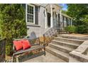 Inviting front entrance with a bench, red cushions, and decorative railings leading to the front door at 747 Channing Nw Dr, Atlanta, GA 30318