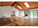 Bright living area boasts hardwood floors, a stone fireplace, and access to outdoor deck at 2528 Chimney Springs Dr, Marietta, GA 30062
