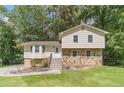 Charming home with stone details, wooden stairs, and a well-maintained lawn at 2645 Holly Berry Trl, Snellville, GA 30039