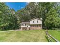 Charming home with a stone accent facade and wooden stairs surrounded by a green lawn at 2645 Holly Berry Trl, Snellville, GA 30039