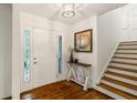 Welcoming foyer with hardwood floors, decorative lighting, and a staircase with wooden steps at 3597 Embry Cir, Atlanta, GA 30341