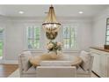This dining room features a chandelier, natural light, and shutters, creating an inviting atmosphere at 4016 Dover Ave, Alpharetta, GA 30009