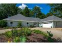 Inviting single-story home featuring a two-car garage, well-kept landscaping, and a circular driveway at 4016 Dover Ave, Alpharetta, GA 30009