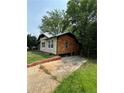 Side view of the house with a stone veneer, wood exterior, and driveway at 1422 Boulevard Se, Atlanta, GA 30315