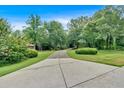 Long concrete driveway leading through a lush, green landscape to the main house at 3656 Ebenezer Rd, Marietta, GA 30066
