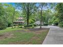 Home with a detached garage, lush landscaping and a long driveway at 3656 Ebenezer Rd, Marietta, GA 30066