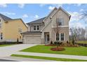 Charming two-story home with stone accents, gray shutters, and a well-manicured lawn at 4770 Briscoe Dr, Cumming, GA 30028