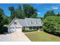 Attractive home boasts a spacious two-car garage and meticulously maintained lawn, creating an inviting exterior at 4824 Dunwoody Station Dr, Atlanta, GA 30338