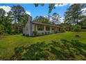 Side view of a newly renovated single-story home with well-maintained lawn and mature trees at 2089 Christian Se Cir, Conyers, GA 30013