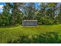 Exterior of a quaint backyard shed that sits in the expansive lawn at 2089 Christian Se Cir, Conyers, GA 30013