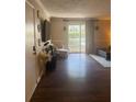 Bright living room with wood floors and sliding doors to the balcony at 3120 Seven Pines Court # 203, Atlanta, GA 30339