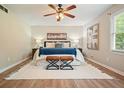 Spacious main bedroom with neutral walls, ceiling fan, natural light, and hardwood floors, creating a serene retreat at 588 Benson Hurst Dr, Mableton, GA 30126