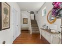 Inviting entryway with hardwood floors, staircase, and elegant console table at 2860 Cooper Brook Dr, Snellville, GA 30078