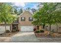 Charming brick townhome with a two-car garage and well-manicured landscaping at 2860 Cooper Brook Dr, Snellville, GA 30078