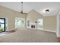 Bright living room with soaring ceilings, a cozy fireplace, and large windows offering plenty of natural light at 4000 Mcpherson Drive Dr, Acworth, GA 30101