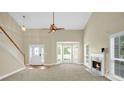 Open concept living room featuring a fireplace, large windows, and a staircase leading to the upper level at 4000 Mcpherson Drive Dr, Acworth, GA 30101