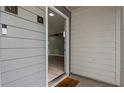 Close up exterior of a condo's entry door with a Ring doorbell and light gray vinyl siding at 47 Arbor End, Smyrna, GA 30080