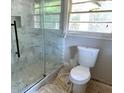 Bright bathroom showcasing a modern glass-enclosed shower and a toilet at 1968 Rosewood Rd, Decatur, GA 30032