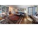 Spacious living room featuring hardwood floors, a large oriental rug, built-in bookshelves, and neutral paint at 2260 Peachtree Nw Rd # B4, Atlanta, GA 30309