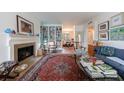 Sunlit living room boasts a fireplace, hardwood floors, stylish decor, and built-in bookshelves at 2260 Peachtree Nw Rd # B4, Atlanta, GA 30309