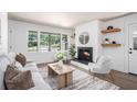 Bright living room with fireplace, neutral furniture, and large windows at 3390 Kenland Se Rd, Smyrna, GA 30082