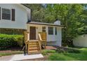 Lovely home exterior featuring a welcoming front entrance with new wooden steps and a cozy front porch at 4030 Tanglewood Rd, Snellville, GA 30039