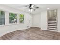 Inviting living room with large windows, new wood-look floors, and staircase at 4030 Tanglewood Rd, Snellville, GA 30039