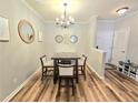 Cozy dining room featuring a wood table with four chairs, accented by a stylish chandelier at 1975 Nocturne Dr # 2206, Alpharetta, GA 30009