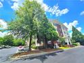 Exterior view of the multi-story building surrounded by lush trees and well-manicured lawn at 1975 Nocturne Dr # 2206, Alpharetta, GA 30009