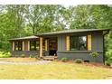 A stylish gray single-story home showing an outdoor space that is freshly cut and maintained at 45 Driskell Ave, Mableton, GA 30126