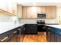 Modern kitchen featuring stainless steel appliances, sleek countertops, and two-tone cabinets with gold hardware at 45 Driskell Ave, Mableton, GA 30126