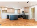 A modern kitchen that shows the island, stainless steel appliances, and sleek hardwood floors at 45 Driskell Ave, Mableton, GA 30126