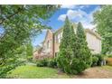 A well-maintained side view showcases meticulous landscaping and lush greenery at 10865 Glenhurst Pass, Duluth, GA 30097