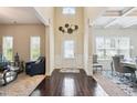 Inviting foyer with hardwood floors, decorative wall art, and views into the living and dining areas at 3796 Village Crossing Ln, Ellenwood, GA 30294
