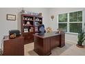 Functional home office with a large desk, built-in bookcase, and natural light, ideal for remote work at 263 Jefferson Ave, Canton, GA 30114