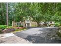 Community entrance features a sign, lush landscaping, and parking for visitors at 1 Biscayne Nw Dr # 112, Atlanta, GA 30309