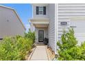 Inviting front porch and walkway with garden bed leading to the home's front door at 3350 Clawing Hawk Way, Douglasville, GA 30135