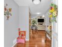 Inviting foyer with hardwood floors leading into a living area with fireplace and TV at 400 Little John Nw Dr, Lilburn, GA 30047