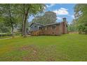 The home has a beautifully maintained lawn with brick accents, an RV, and a cozy deck at 1031 Washington Ave, Woodstock, GA 30188